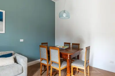 a dining room with a wooden table and chairs at La casa di Oreste al Vaticano in Rome
