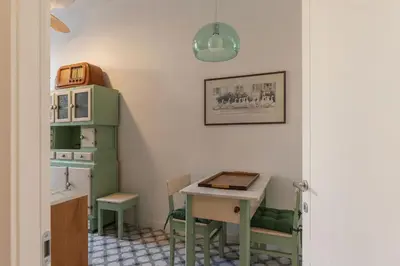 a room with a table and a small table with chairs at La casa di Oreste al Vaticano in Rome