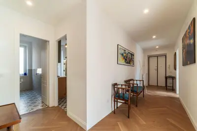a living room with white walls and a table and chairs at La casa di Oreste al Vaticano in Rome