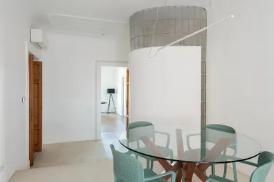 a dining room with a glass table and chairs at Vittorio Luxury Panoramic Apartment in Rome