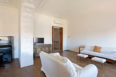 a white living room with a couch and a fireplace at Vittorio Luxury Panoramic Apartment in Rome