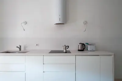 a kitchen with two sinks and a white counter top at Vittorio Luxury Panoramic Apartment in Rome