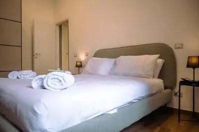 a bedroom with a bed with towels on it at Collection39 Doria Smart Apartment in Rome