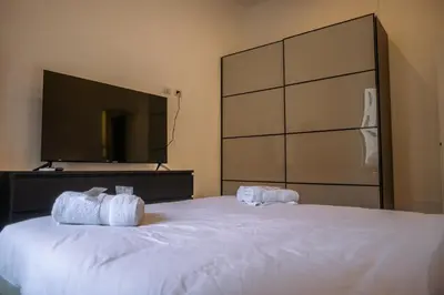 a bedroom with a large white bed with two towels at Collection39 Doria Smart Apartment in Rome