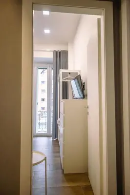 a room with a white refrigerator and a window at Collection39 Doria Smart Apartment in Rome