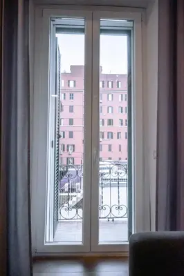 a sliding glass door with a view of a building at Collection39 Doria Smart Apartment in Rome