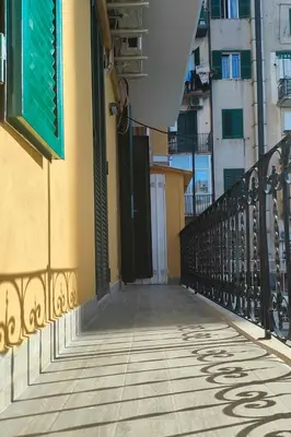 a walkway leading to a building with doors on it at Collection39 Doria Smart Apartment in Rome