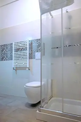 a bathroom with a toilet and a shower at Collection39 Doria Smart Apartment in Rome