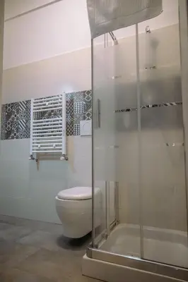 a bathroom with a toilet and a shower at Collection39 Doria Smart Apartment in Rome