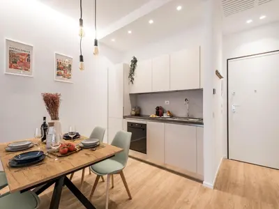 a kitchen and dining room with a wooden table and chairs at The Best Rent - Spacious Apartment Near Castel Sant’Angelo in Rome