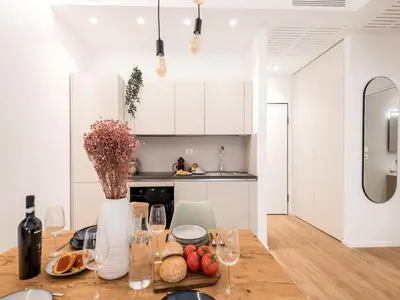 a kitchen with a table with a vase of flowers at The Best Rent - Spacious Apartment Near Castel Sant’Angelo in Rome