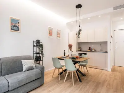 a living room with a couch and a table and chairs at The Best Rent - Spacious Apartment Near Castel Sant’Angelo in Rome