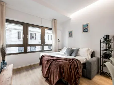 a white bedroom with a bed and a window at The Best Rent - Spacious Apartment Near Castel Sant’Angelo in Rome