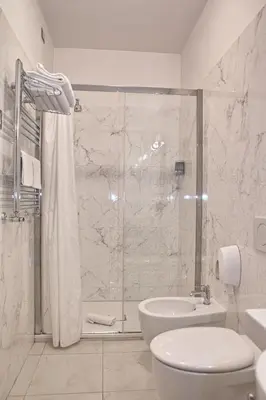 a bathroom with a shower and a toilet and a sink at Ghv Rooms Roma in Rome