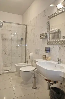 a bathroom with two sinks and a shower and a toilet at Ghv Rooms Roma in Rome