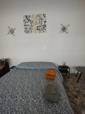 a bedroom with a bed with an orange bag on it at Il Mulo Volante - Panoramico attico con terrazzo a Trastevere in Rome