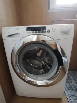 a washing machine with its door open in a bathroom at Il Mulo Volante - Panoramico attico con terrazzo a Trastevere in Rome