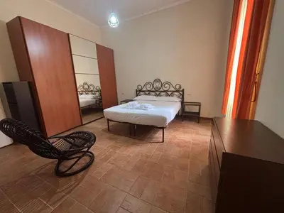 a bedroom with a bed and a chair and a mirror at Trastevere View Point in Rome