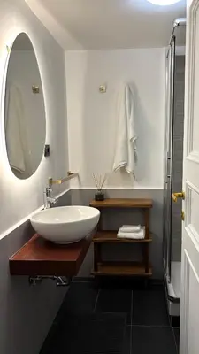 a bathroom with a sink and a mirror at Elegant Apartment in Rome's Historic Center in Rome