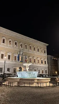a large building with a fountain in front of it at Elegant Apartment in Rome's Historic Center in Rome