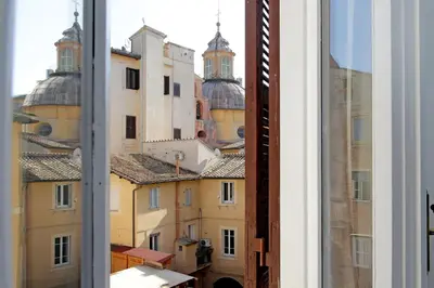 a view of the roofs of buildings from a window at 4BNB - Navona Rooftop in Rome