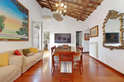 a living room with a table and a couch at 4BNB - Navona Rooftop in Rome