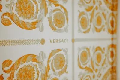 a book with orange and white designs on the wall at 4 Min From Metro ''A'' Apt 15 Min from Colosseum in Rome