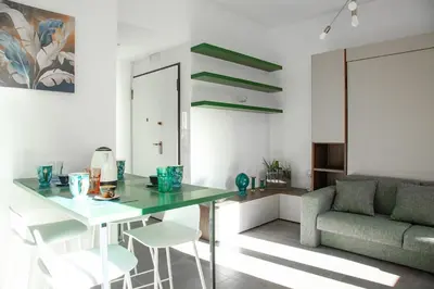 a living room with a table and chairs and a couch at 4 Min From Metro ''A'' Apt 15 Min from Colosseum in Rome