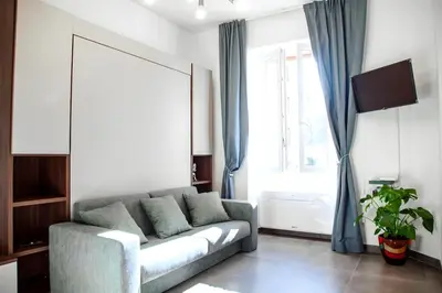 a living room with a couch and a window at 4 Min From Metro ''A'' Apt 15 Min from Colosseum in Rome