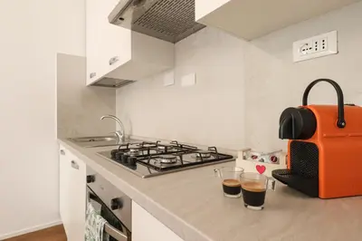 a kitchen with two glasses of wine on a counter at Apartments Portuense in Rome