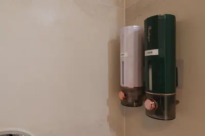 a coffee dispenser on the wall of a bathroom at Apartments Portuense in Rome