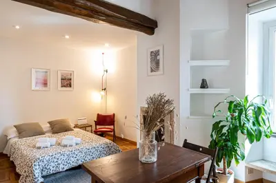 a living room with a bed and a table at Piazza Navona the most central apartment in Rome
