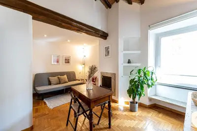 a living room with a couch and a table at Piazza Navona the most central apartment in Rome