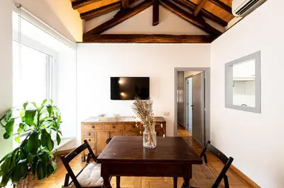 a dining room with a table and a tv at Piazza Navona the most central apartment in Rome