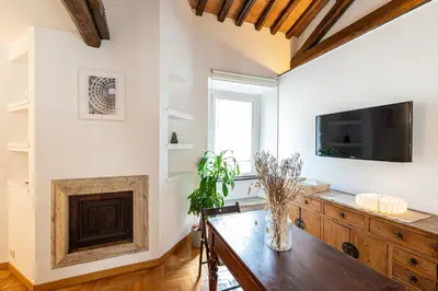 a living room with a wooden table and a tv at Piazza Navona the most central apartment in Rome