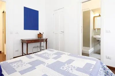 a bedroom with a bed and a desk and a sink at Casa Cestia San Saba in Rome