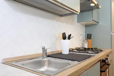 a kitchen counter with a sink and a stove at Casa Cestia San Saba in Rome