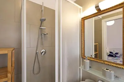a bathroom with a shower and a mirror at Casa Cestia San Saba in Rome