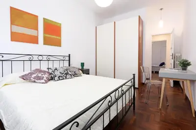 a bedroom with a large bed and a desk at Casa Cestia San Saba in Rome