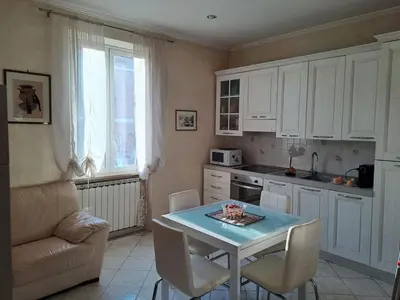 a kitchen with a table and chairs and a couch at Da Fedelisa in Rome