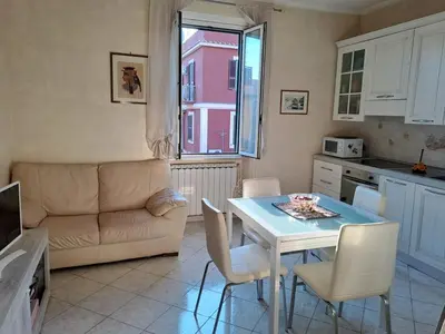 a kitchen and living room with a table and a couch at Da Fedelisa in Rome