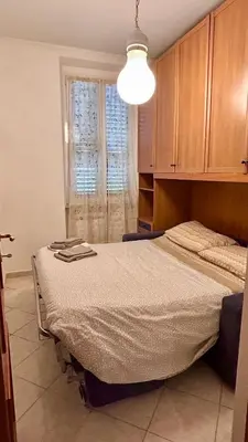 a bedroom with a bed and a window at Da Fedelisa in Rome