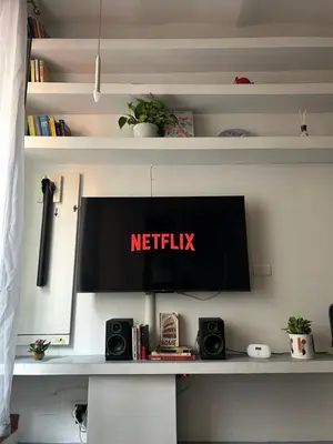 a desk with a netflix sign on a wall at Brina-House, Mini Apartment in Rome