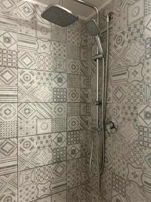 a shower in a bathroom with a tile wall at Brina-House, Mini Apartment in Rome