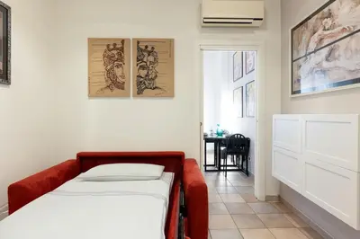 a small bedroom with a bed and a table at Casa vacanze Alle Mura Aureliane in Rome