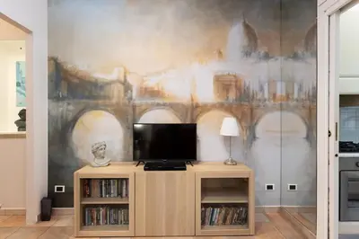 a living room with a tv and a painting on the wall at Casa vacanze Alle Mura Aureliane in Rome