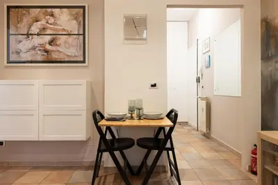 a dining room with a table and two chairs at Casa vacanze Alle Mura Aureliane in Rome