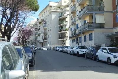 a row of cars parked on a street next to buildings at Casa Vacanze Fausta in Rome