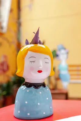 a toy figurine of a doll with a head at Casa d' artista Margot in Rome