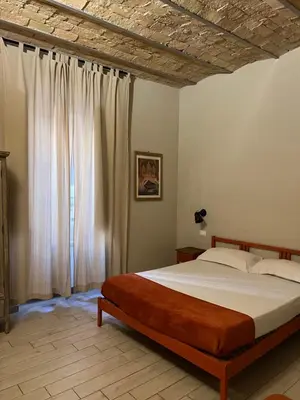 a bedroom with a bed and a large window at GA Holidays Home2 in Rome